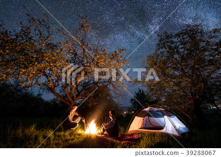 Tourists at campfire near tent. Night camping 39288067