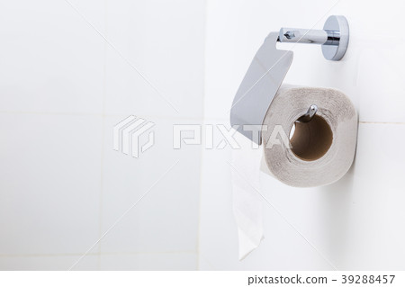 Roll of white toilet paper in a white bathroom Roll of white toilet paper in a white bathroom 39288457