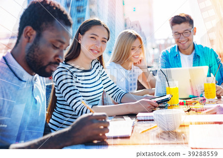 Cheerful woman working on a project with her co Cheerful woman working on a project with her co 39288559