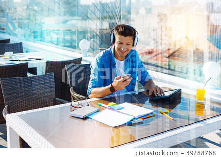 Inspired young man listening to music while Inspired young man listening to music while 39288768
