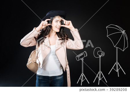 Positive young woman taking a photo and looking 39289208