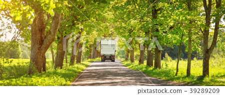 Truck moving on alley in summer Truck moving on alley in summer 39289209
