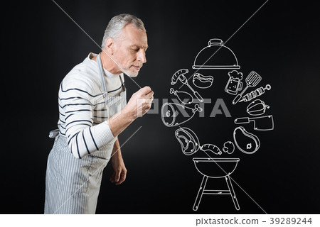 Calm professional cook smelling the dish while Calm professional cook smelling the dish while 39289244