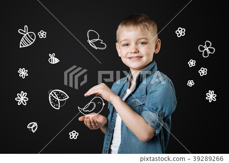 Kind child holding a bird after saving it in the 39289266