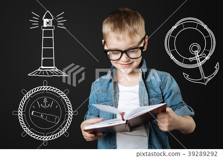 Clever boy reading his notes while planning a sea Clever boy reading his notes while planning a sea 39289292