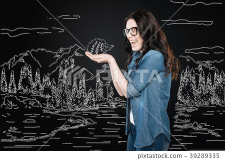 Young woman laughing while holding a little 39289335