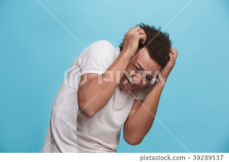 Portrait of the scared man on blue 39289537