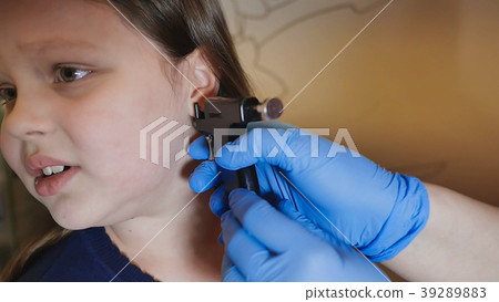 Adorable little girl having ear piercing process Adorable little girl having ear piercing process 39289883