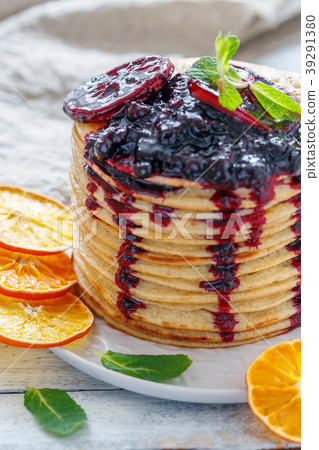 Pancakes with berry sauce and mint close-up. Pancakes with berry sauce and mint close-up. 39291380