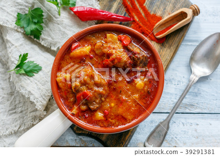 Thick meat soup with potatoes and paprika. 39291381