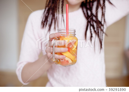 Young pretty woman holding mason jar with lemonade Young pretty woman holding mason jar with lemonade 39291890