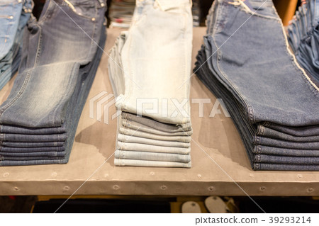 stack of blue jeans in a shop. shopping sale 39293214