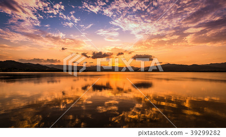 Twilight sky and clouds reflect on water surfa 39299282