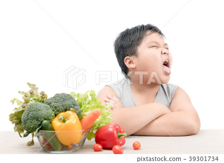 boy with expression of disgust against vegetables boy with expression of disgust against vegetables 39301734