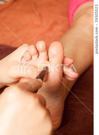 reflexology foot massage by wood stick 39305023