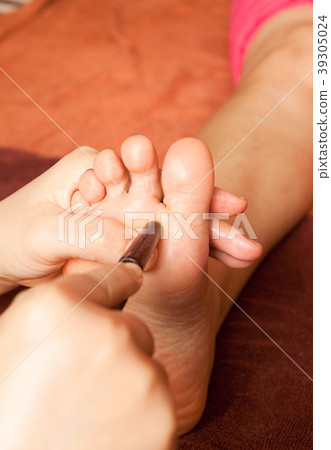 reflexology foot massage by wood stick 39305024