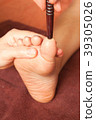 reflexology foot massage by wood stick 39305026