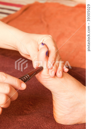 reflexology foot massage by wood stick 39305029