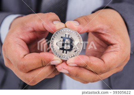silver bitcoin in hand of business man silver bitcoin in hand of business man 39305622