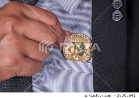business man in suit pick bitcoin in to pocket business man in suit pick bitcoin in to pocket 39305641