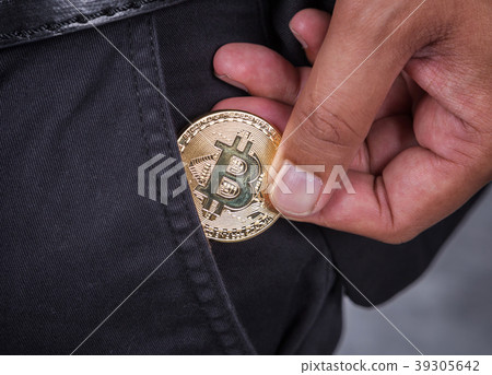 close up man pick bitcoin in to pocket 39305642