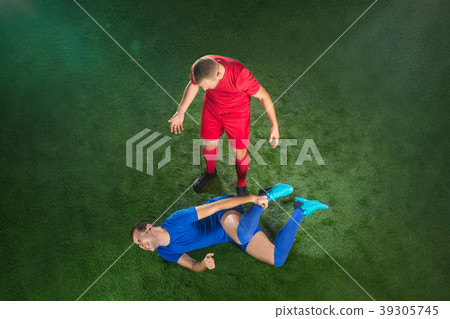 Male soccer player suffering from leg injury on Male soccer player suffering from leg injury on 39305745