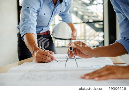 Architects engineer discussing at the table with b Architects engineer discussing at the table with b 39306626