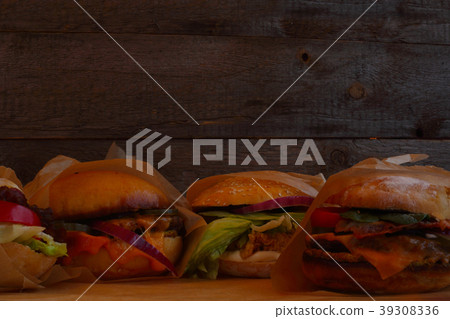 Burgers on wooden background Burgers on wooden background 39308336