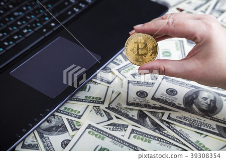Female hand holds bitcoin Female hand holds bitcoin 39308354