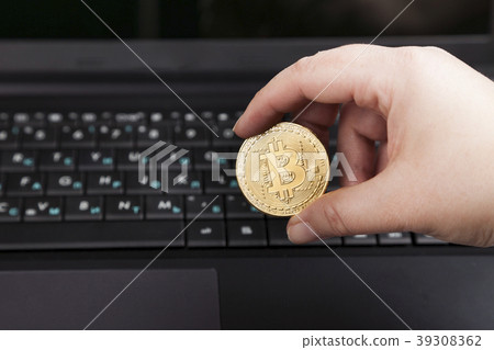 Female hand holds bitcoin 39308362