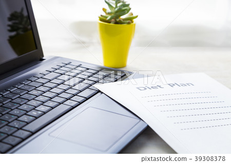 Laptop, plant and diet plan 39308378