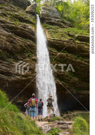 Active tourists looking at Pericnik waterfall in Active tourists looking at Pericnik waterfall in 39309203
