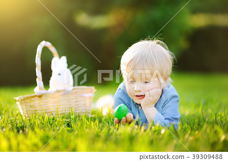 Charming little boy hunting for easter egg Charming little boy hunting for easter egg 39309488
