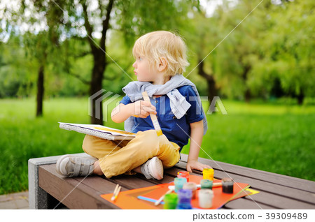 Cute little boy drawing with colorful paints 39309489