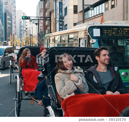 Foreign tourists on a rickshaw Foreign tourists on a rickshaw 39310570