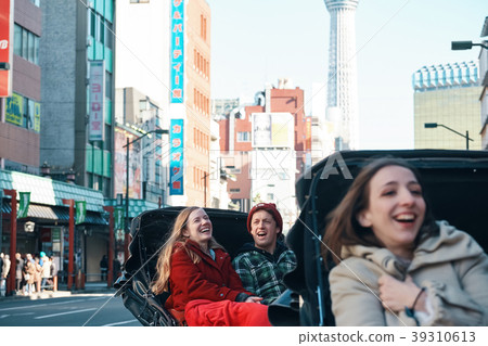 Foreign tourists on a rickshaw 39310613
