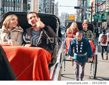 Foreign tourists on a rickshaw 39310630
