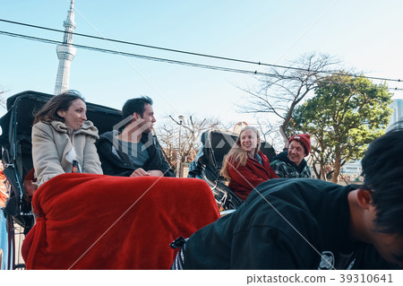 Foreign tourists on a rickshaw 39310641