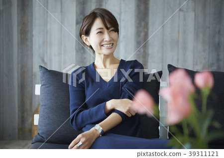 Woman relaxing in the living room Woman relaxing in the living room 39311121