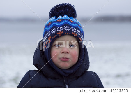 Toddler with snivel and red cheeks. Outdoor winter 39313233