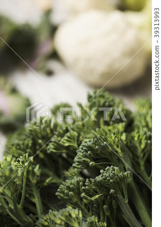 raw stems of broccolini on a table raw stems of broccolini on a table 39313993