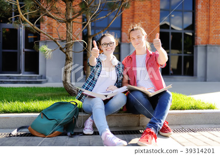 Young students show sight thumbs up and good luck Young students show sight thumbs up and good luck 39314201