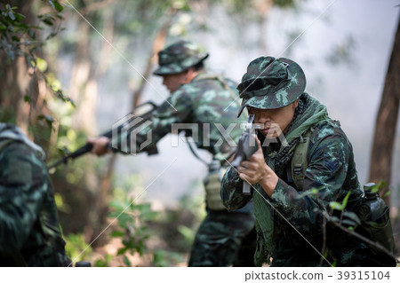 Squad of soldiers patrolling across the forest. Squad of soldiers patrolling across the forest. 39315104