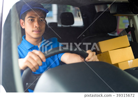 Delivery driver driving car with packages Delivery driver driving car with packages 39315672