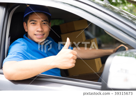 Delivery driver driving car with packages  39315673
