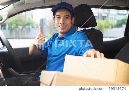 Delivery driver driving car with packages Delivery driver driving car with packages 39315674