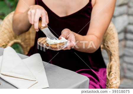 Female hands make sandwich of rye bread and cheese Female hands make sandwich of rye bread and cheese 39318075