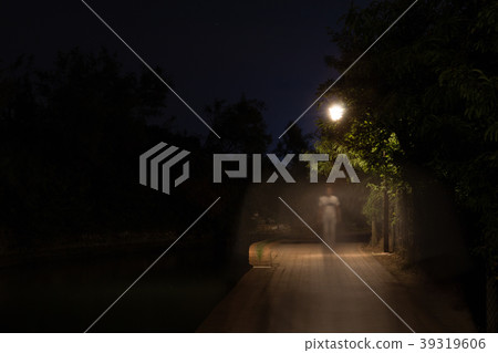 Double exposure night scene of person walking dark 39319606