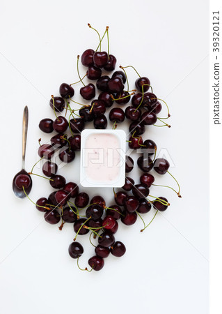 Container with yogurt and a bunch of fresh cherry Container with yogurt and a bunch of fresh cherry 39320121
