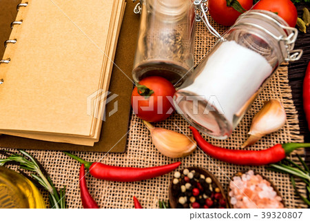 Open cook book and various spices composition 39320807